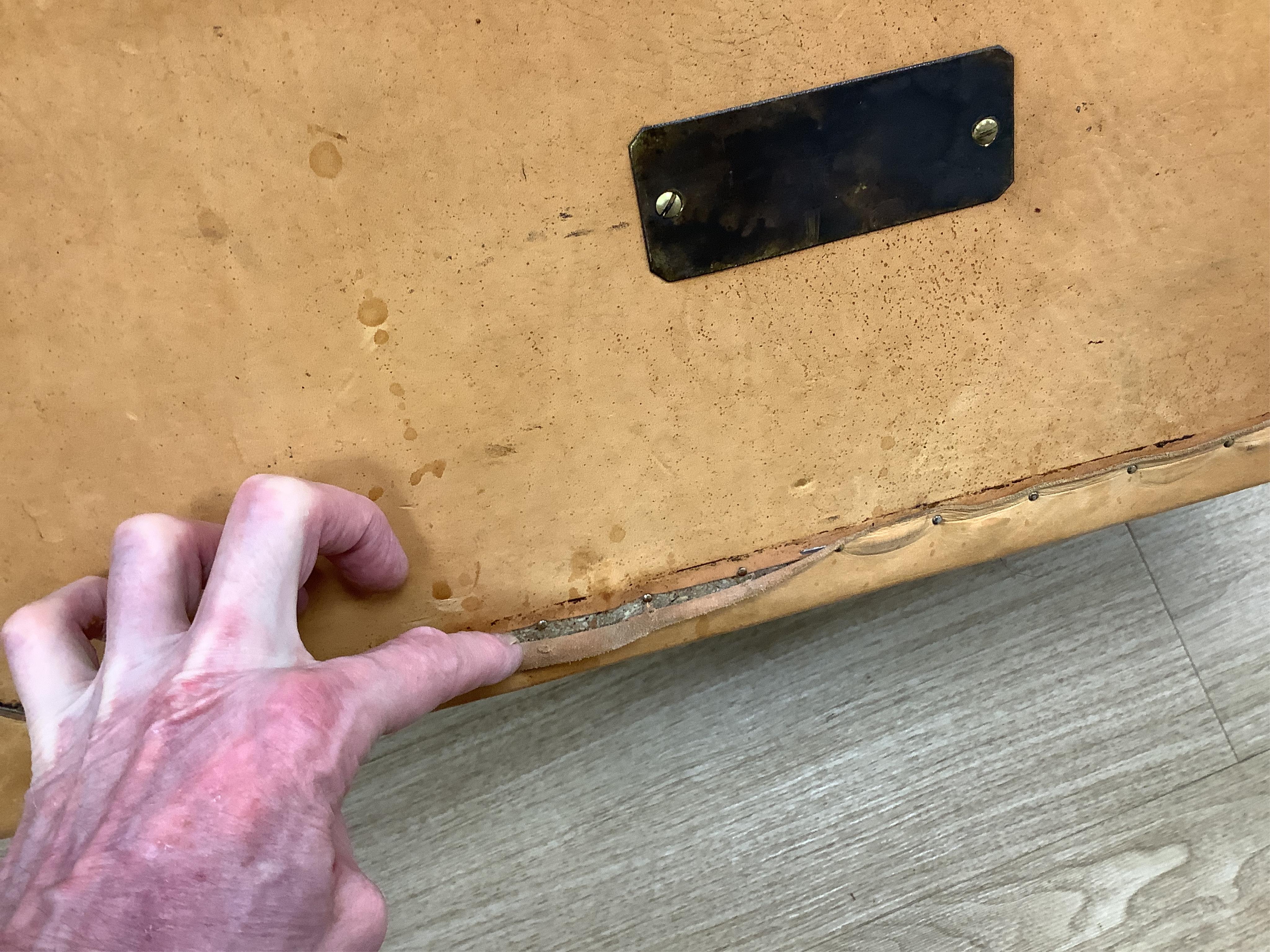 A leather trunk and top hat in box